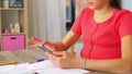 Girl with smartphone distracting from homework