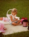 Girl with smartphone sit on cover on green grass Royalty Free Stock Photo