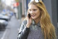 Girl with smartphone walking on city