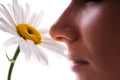 Girl smelling camomile Royalty Free Stock Photo