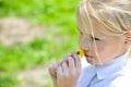 Girl smelling dandelion