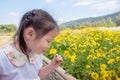 Girl smelling flower in garden Royalty Free Stock Photo