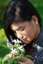 Asian Woman Smelling Flowers