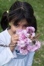 Girl smelling pink flowers