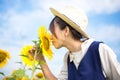 Girl smells sunflower in nature Royalty Free Stock Photo