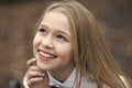 Girl smile with cute face, beauty. Little child smiling with long blond hair, hairstyle outdoor. Baby beauty, hair and