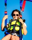 Girl smile in parasail parashute mid-air. Parasailing safety and experience concept