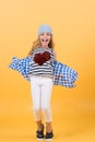 Girl smile with red heart on shirt on orange background