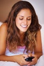 Girl, smile and texting on smartphone in bedroom for sharing, funny post or meme on social media. Female student, happy