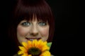 Girl Smiling Behind Sunflower Royalty Free Stock Photo