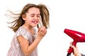 Girl is smiling at blow dryer - hair dryer Royalty Free Stock Photo