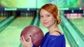 Girl smiling with bowling ball in her hands