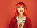 Girl smiling with bright artificial hair in ethnic jewelry.