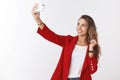 Girl smiling confident sassy having lucky day feeling upbeat taking selfie sunny spring weather wearing red jacket