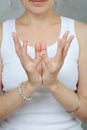 Woman smiling doing meditation yoga mudra of hands