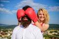 Girl smiling face covers male face with boxing gloves. Cunning tricks to win. Guess who game. Relations game or struggle