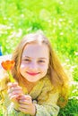 Girl on smiling face holds red tulip flower, enjoy aroma. Youth and carefree concept. Girl lying on grass, grassplot on