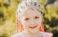 Girl smiling with hairstyle dreadlocks. Kid with fashionable hair outdoor. Happy child outside. Royalty Free Stock Photo