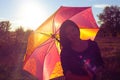 Girl smiling hiding under colorful umbrella Royalty Free Stock Photo