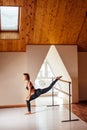 Girl smiling and looking in mirror while stretching body in fitness class Royalty Free Stock Photo