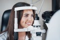 Girl smiling during the process. Optometrist checking vision of young beautiful woman Royalty Free Stock Photo