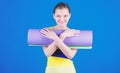 Girl smiling slim fit athlete hold fitness mat. Fitness and stretching. Stretching muscles. Getting into the yoga groove