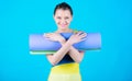 Girl smiling slim fit athlete hold fitness mat. Fitness and stretching. Stretching muscles. Getting into the yoga groove