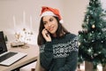 Girl smiling and talking on the phone in winter holiday scenery Royalty Free Stock Photo