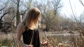 Girl smilling near river with glass