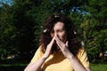 Girl sneezes because of the poplar fluff. Allergic reaction to poplar fluff