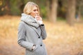 Girl sneezing in tissue. Young woman blowing her nose on the park. Woman portrait outdoor sneezing because cold and flu Royalty Free Stock Photo