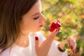 Girl sniffing a red rose in San Valentine day