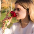 Girl sniffing a red rose in San Valentine day