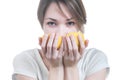 Girl sniffing two parts of lemon Royalty Free Stock Photo