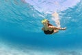 Girl in snorkeling mask dive underwater in blue sea lagoon Royalty Free Stock Photo