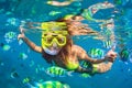 Girl in snorkeling mask dive underwater with coral reef fishes Royalty Free Stock Photo