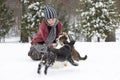 Girl in the snow with her dogs