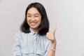 Girl with snow white teeth laughs shows thumbs up Royalty Free Stock Photo