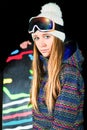 Girl with snowboard photographed in the studio with black background