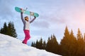 Girl with snowboard in snowy mountains Royalty Free Stock Photo