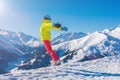 Girl snowboarder jumping and having fun in the winter ski resort. Royalty Free Stock Photo