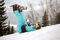 Girl snowboarder resting on the slope
