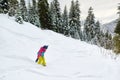 Girl snowboarder rides freeride in forest