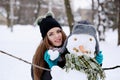 Girl with a snowman and a heart made of snow Royalty Free Stock Photo