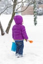 Girl in snowy front yard