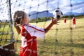 Girl, soccer and ball with goal keeper for save, match or game from scoring point on outdoor field. Team of football Royalty Free Stock Photo