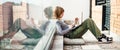 Girl social media influencer sitting on patio floor using laptop Royalty Free Stock Photo