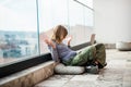 Girl social media influencer sitting on patio floor using laptop Royalty Free Stock Photo