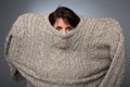 A girl with a social phobia hides her face in a sweater. Royalty Free Stock Photo