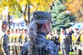 Girl soldier of the Ukrainian army is standing in the parade. Defender of Ukraine Day. Armed forces of Ukraine